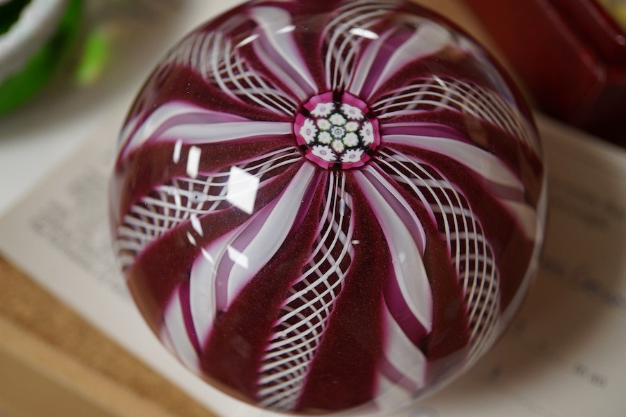 Two Perthshire glass Christmas paperweights for 1981 and 1983, a Perthshire miniature Latticino weight, 18/400, dated 1982, and a Selkirk glass Millefiori crown paperweight, 1982, (4) Largest Perthshire paperweight 8cm